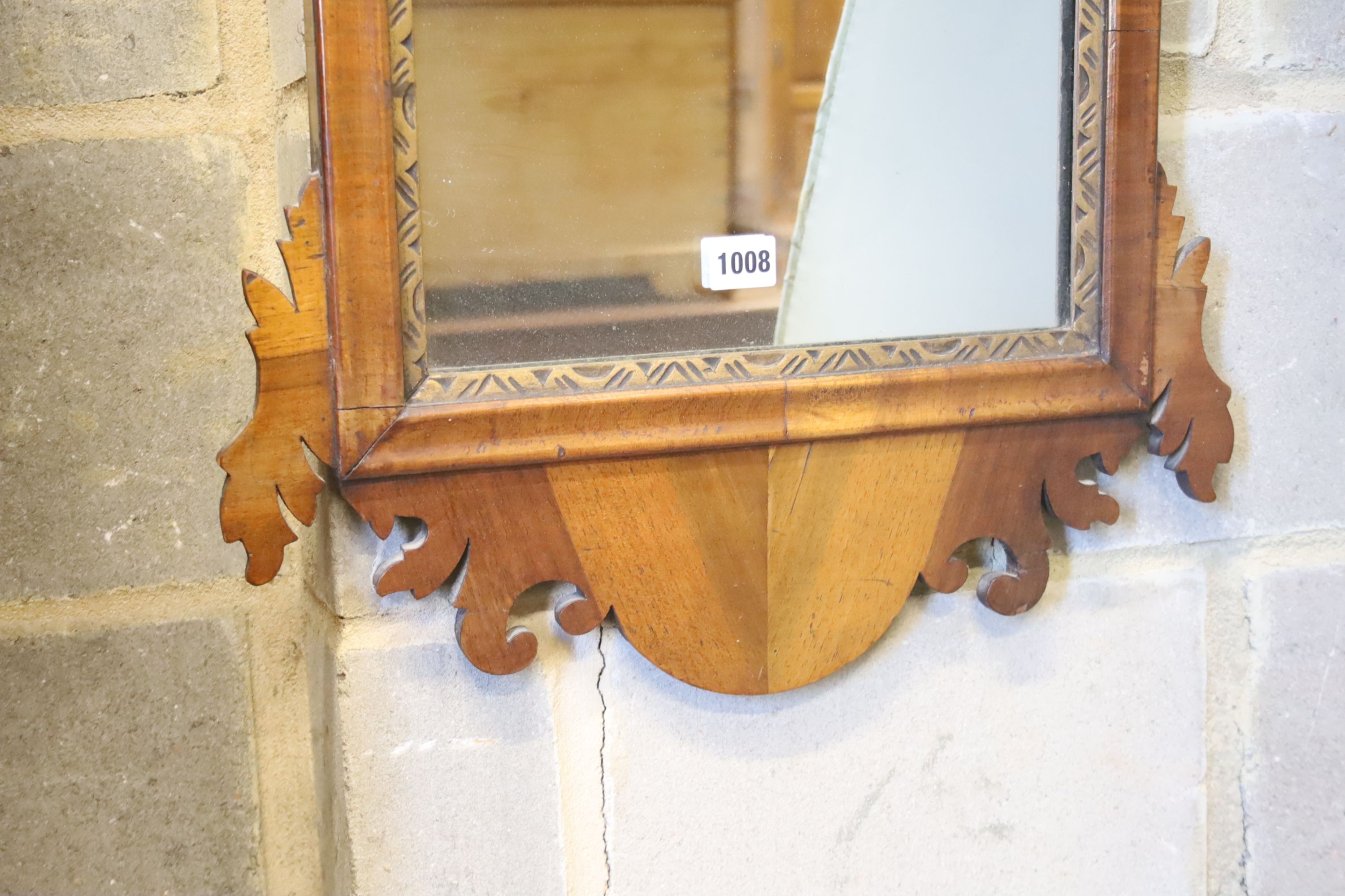 A George III style walnut fret cut and carved giltwood wall mirror, width 49cm, height 86cm